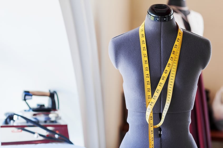 Black dummy with measuring tape in tailors studio.jpeg