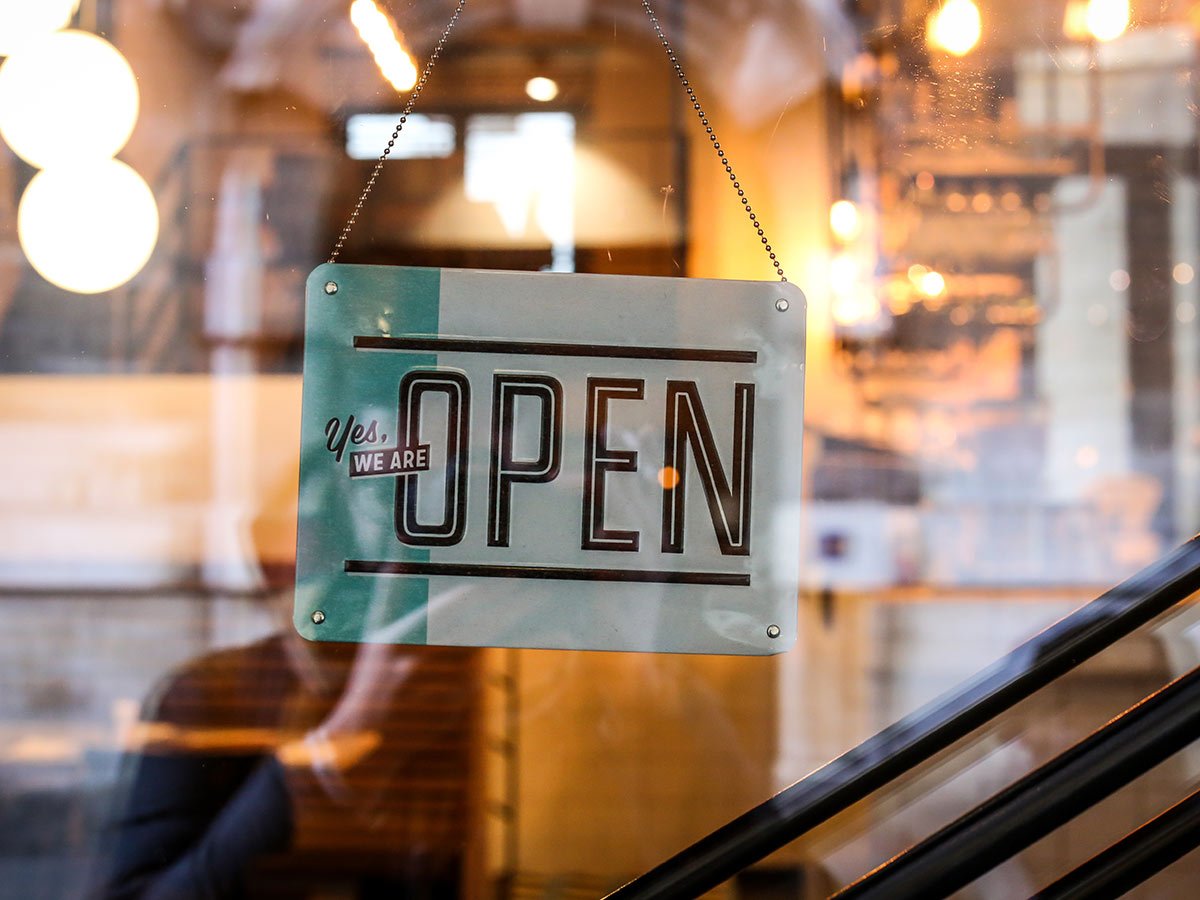 open-sign-hanging-in-store-window