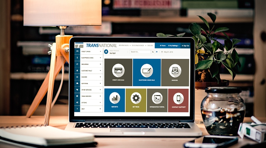 TransNational Payments' payment gateway displayed on the laptop in the home office