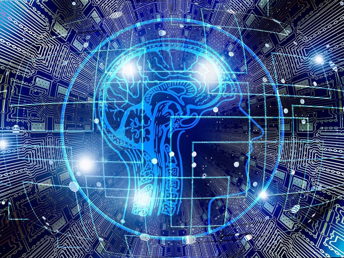 Large image of a human brain projected onto a tunnel lined with computer microchips