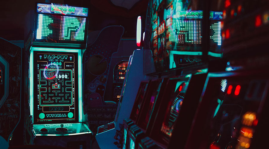 Neon arcade video game machines in a dark room