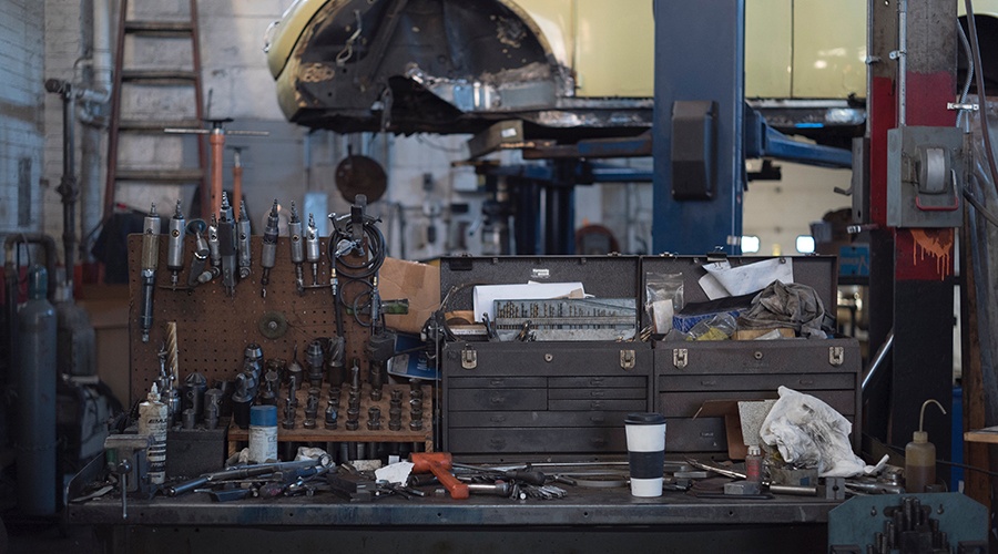 Work bench filled with auto repair tools at an auto shop