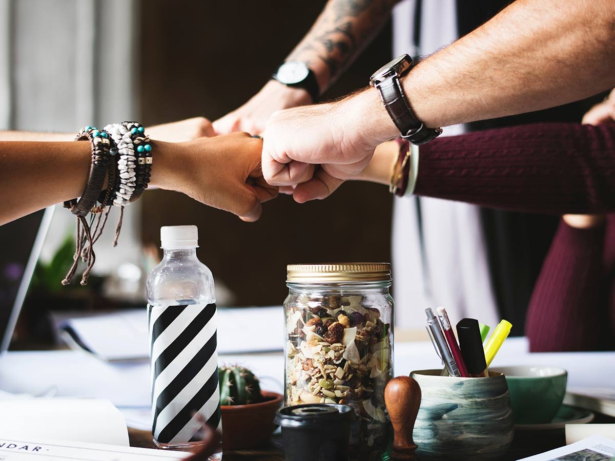 hands-in-fist-bump-over-the-table