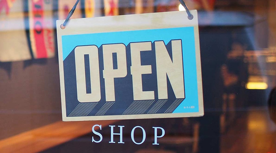 Open sign hanging inside the store window