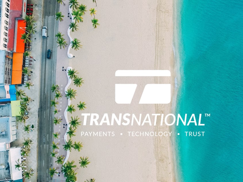 Aerial view of the beach and oceanside road with TransNational Payments logo